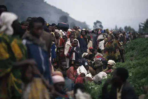 A crowd of refugees are seen fleeing the civil war make the journey from Rwanda to Zaire.