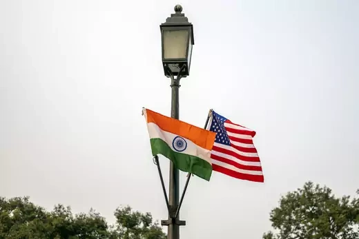 The national flags of India and America hang from a lamppost in New Delhi, India