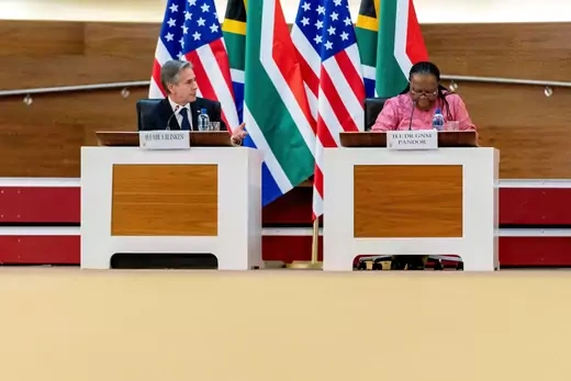 Sitting in front of the South African and United States' flags, Secretary of State Antony Blinken speaks with South Africa's Foreign Minister Naledi Pandor. 