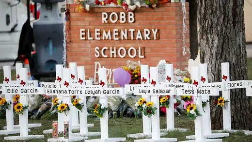 Crosses with the names of victims of a school shooting at a memorial outside Robb Elementary school