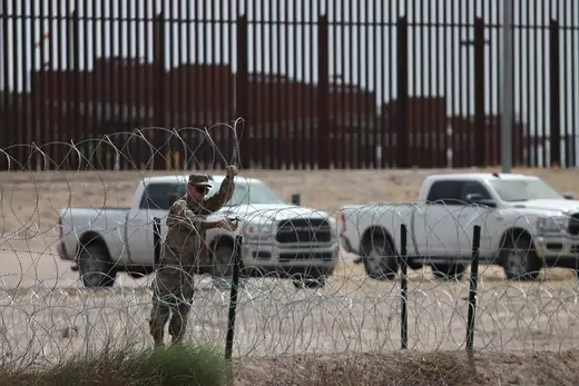 A member of the Texas National Guard puts up fencing along the U.S.-Mexico border to prepare for a surge in migration that is expected after Title 42 ends.
