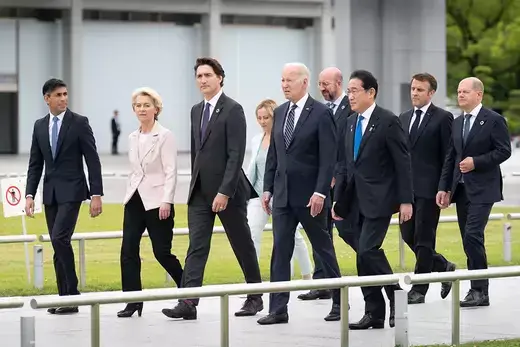 Leaders of G7 countries walk alongside one another.