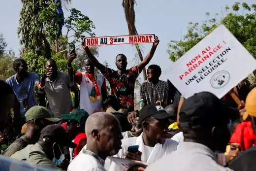 A protester holds up a sign reading "no to third term" while attending a demonstration against the possible third term ambition of President Macky Sall, in Dakar, Senegal. 