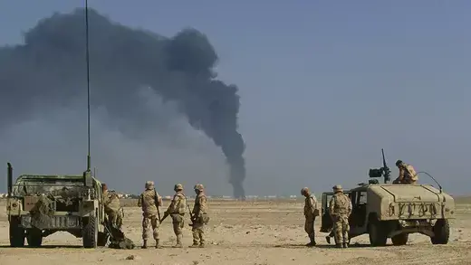 U.S. soldiers arrive at a burning oil refinery in Al-Khafji, Saudi Arabia, during the Gulf War.