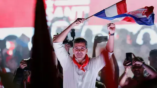 Santiago Pena waves flag at campaign rally