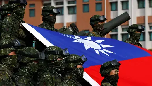 Taiwanese soldiers stand around flag