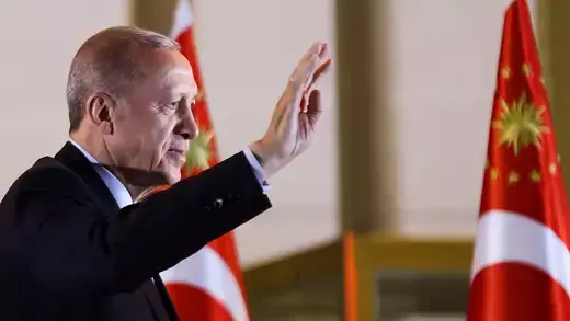 Erdogan waves in front of Turkish flags
