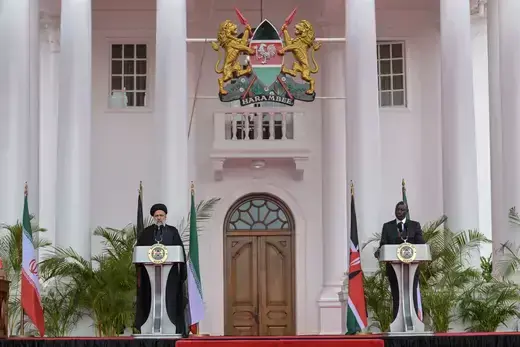 Standing in front of podiums, Iranian President Ebrahim Raisi (L) attends a press conference alongside Kenyan President William Ruto (R) at the State House in Nairobi on July 12, 2023.