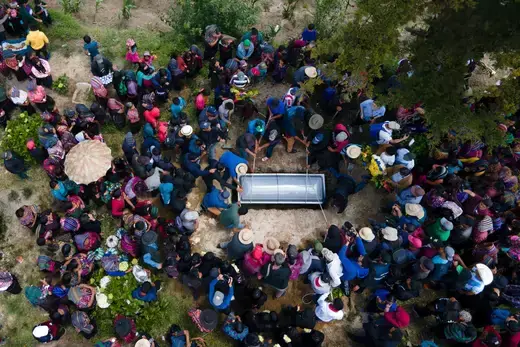 The casket of a migrant teenager who suffocated in a truck in Texas is buried in Guatemala.