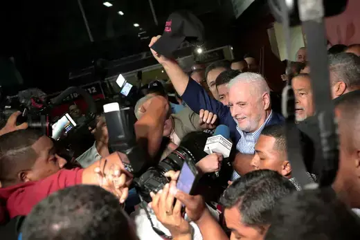 Panama’s former President Ricardo Martinelli waves to supporters while leaving a courthouse in Panama City on August 10, 2019. Martinelli’s cap reads “I survived Varela,” referring to Panama’s former President Juan Carlos Varela.
