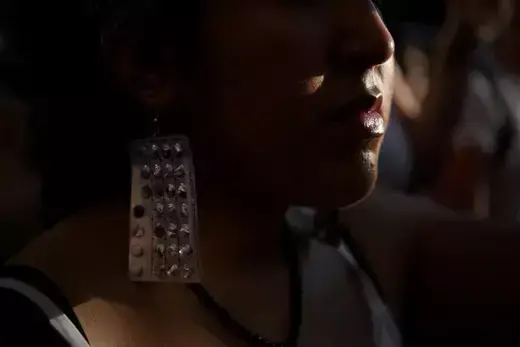 An abortion rights protester wears earrings made of birth control packets as protesters gather outside of the federal courthouse in downtown Houston, Texas, after the United States Supreme Court ruled in the Dobbs v Women's Health Organization abortion case, overturning the landmark Roe v Wade abortion decision, June 24, 2022.