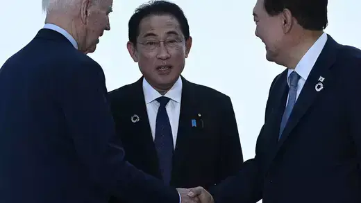 US President Joe Biden, Japan's Prime Minister Fumio Kishida, and South Korea's President Yoon Suk Yeol greeting each other.