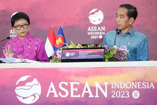Indonesian Foreign Minister Retno Marsudi speaks to media during a press conference as Indonesian President Joko Widodo listens.