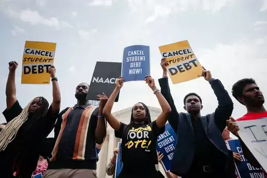Protestors hold "cancel student debt" signs outside the U.S. Supreme Court.