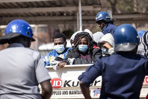 Police officers stand guard as Zimbabwean election observers await their court hearing after being arrested for the alleged unlawful tabulation of election results.
