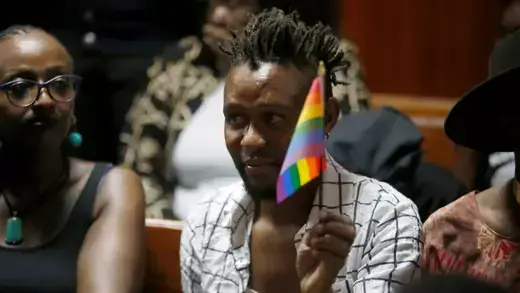 An LGBT activist holds the rainbow flag during a court hearing in the Milimani high Court in Nairobi in Nairobi, Kenya.