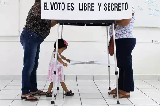 Women cast their ballot at a polling station as Mexico holds a referendum on whether President Andres Manuel Lopez Obrador should continue in office, in Tuxla Chico, in Chiapas state, Mexico April 10, 2022. The text reads: "The vote is free and secret".