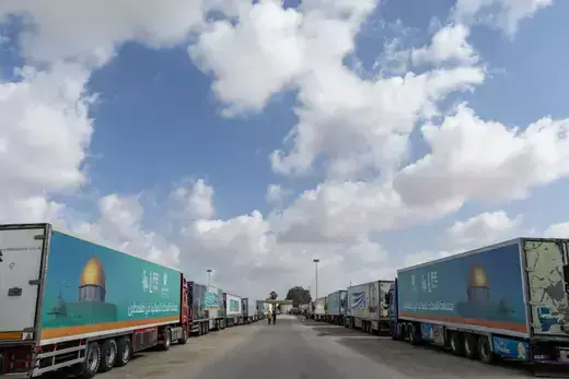 Aid convoy trucks wait at the Rafah border crossing for clearance to enter Gaza on October 19, 2023 in North Sinai, Egypt.