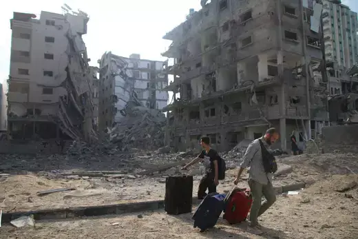 Palestinian citizens evacuate their homes damaged by Israeli airstrikes on October 10, 2023 in Gaza City, Gaza.