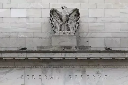 A stone bald eagle perches on the Federal Reserve building in Washington, DC.