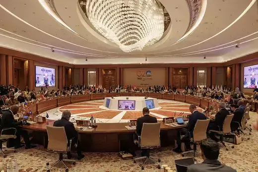 World leaders sit around a circular table at the G20 summit in New Delhi, India.