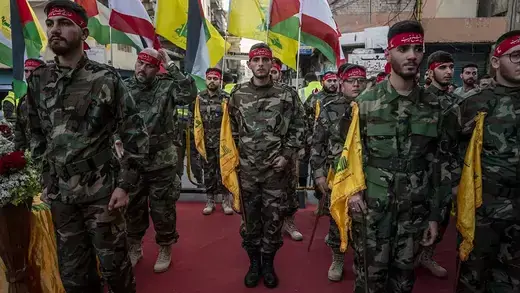 Militants in Beirut, Lebanon, stand at attention during the funeral of a Hezbollah member killed during border clashes with Israel