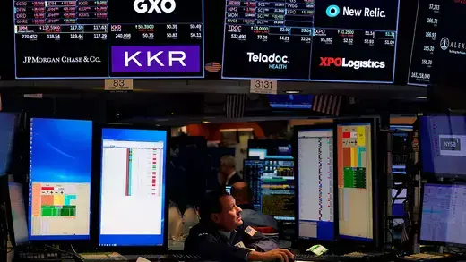 Traders work on the floor during the opening bell of the New York Stock Exchange in New York City.