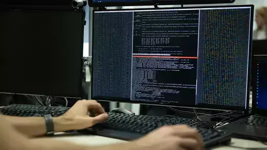 A cybersecurity agent checks data on a computer.