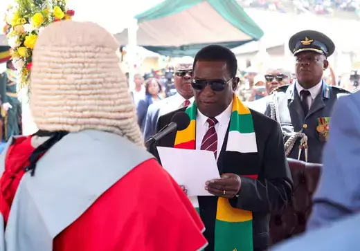 Holding a piece of paper, Zimbabwe's President Emmerson Mnangagwa takes an oath of office during his inauguration at the National Sports Stadium in Harare, Zimbabwe September 4, 2023.