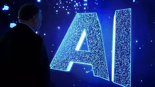 A visitor watches an AI (Artificial Intelligence) sign on an animated screen at the Mobile World Congress (MWC), the telecom industry's biggest annual gathering.
