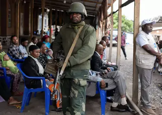 A Congolese soldier stands guard as civilians gather to enrol with the electoral commission as voters at the Zanner Institute centre in Goma, North Kivu province of the Democratic Republic of the Congo.