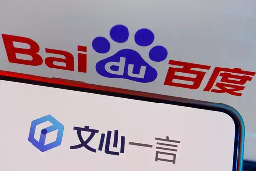 The logo of Baidu's AI chatbot Ernie Bot is displayed near a screen showing the Baidu logo, in this illustration picture taken June 28, 2023