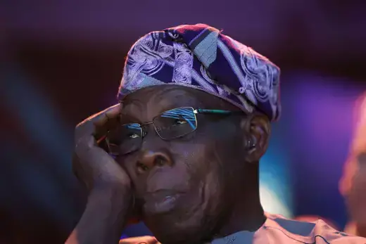 Former President of Nigeria, Olusegun Obasanjo, is pictured in a close-up shot with his head resting on his hand.