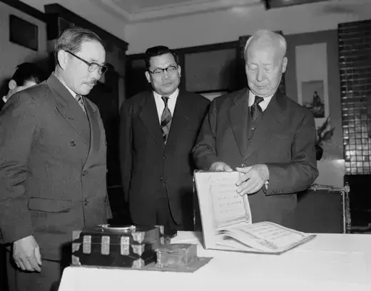 South Korean President Rhee Syngman leafs through the mutual defense treaty between the United States and Republic of Korea on January 29, 1954.