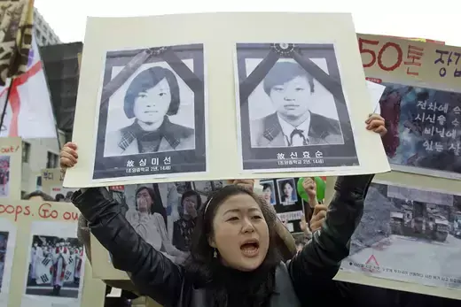 A protester shouts anti-American slogans while holding a poster of the two students accidentally killed by U.S. officers in Seoul.