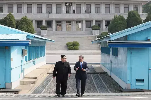 South Korean President Moon Jae-in and North Korean President Kim Jong Un walk along the demilitarized zone separating North and South Korea