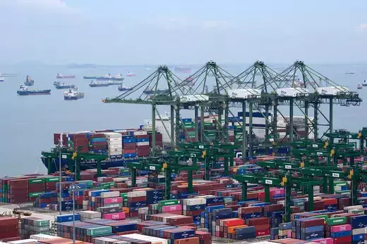 Containers are loaded at the Port of Singapore, the second largest port in the world.