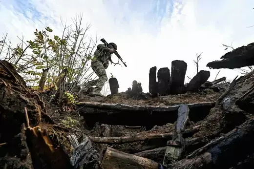 A serviceman of the 65th Mechanized Brigade crosses a trench at the Russian positions taken by the 65th Mechanized Brigade in the Zaporizhzhia Region of southeastern Ukraine on November 4, 2023.