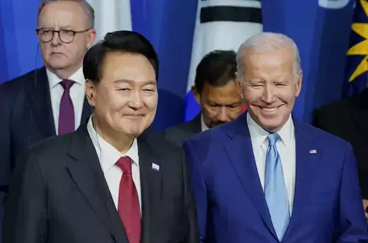 South Korea's President Yoon Suk Yeol as viewed smiling to the left of U.S. President Joe Biden, who is also smiling.
