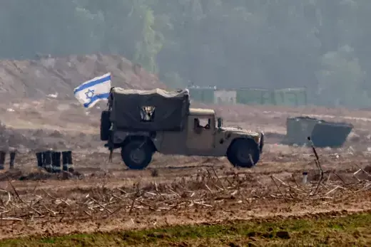 An Israeli flag on a military vehicle at the border with Gaza