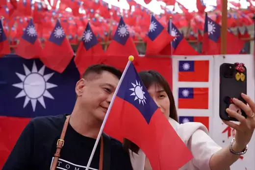 (A couple pose with a Taiwanese flag on October 09, 2023 in New Taipei City, Taiwan.)