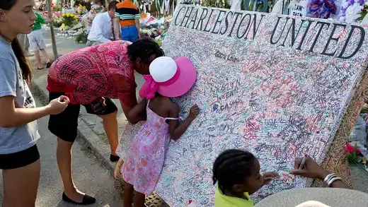 People grieving at the site of the site of the church shooting massacre in Charleston, South Carolina