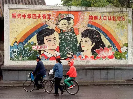 A decaying mural promoting China's one-child policy can be seen from a street in Beijing, China.