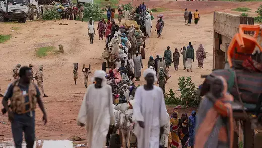 Sudanese refugees fleeing conflict in the Darfur region cross the border between Sudan and Chad.