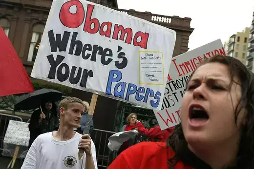 Members of the Tea Party hold a sign reading "Obama Where's Your Papers" during a protest.