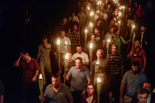 White nationalists, holding tiki torches, march on the grounds of the University of Virginia ahead of the Unite the Right rally in Charlottesville, Virginia. 