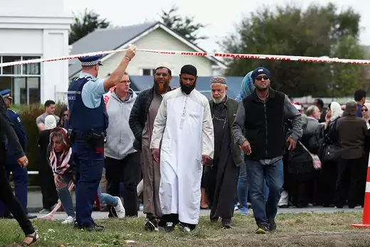 People walk under police tape as they leave after prayers at Linwood Islamic Center in Christchurch, New Zealand.