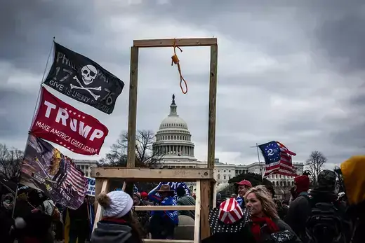Trump supporters erect gallows amid protests and riots in front of the U.S. Capitol building, where many clash with police and damage government property.
