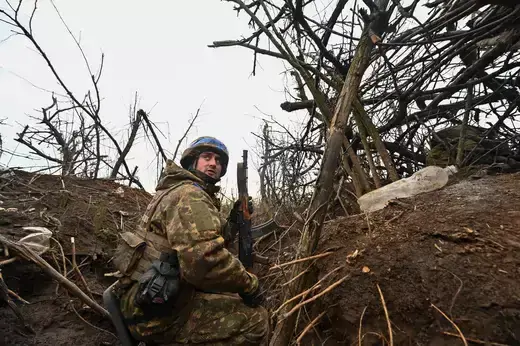A Ukrainian serviceman of the 65th Mechanised Brigade of the Ukrainian Armed Forces looks on from a trench in the Zaporizhzhia region of Ukraine on February 21, 2024