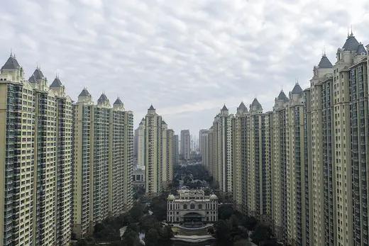 Rows of identical high-rise residential buildings mirror each other across the park.